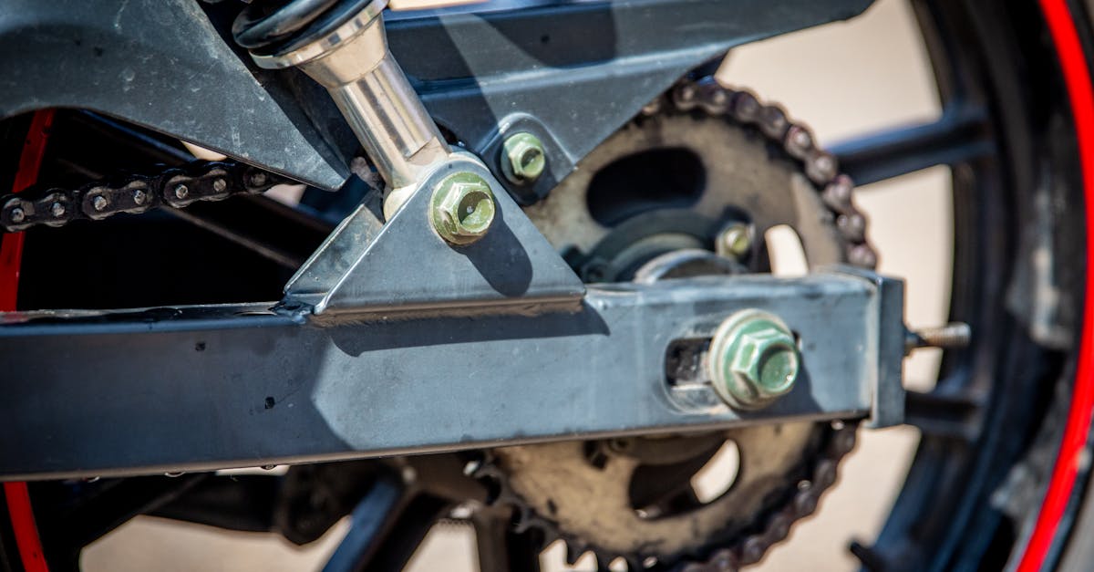 Detailed view of a motorcycle chain and wheel showcasing mechanical precision.